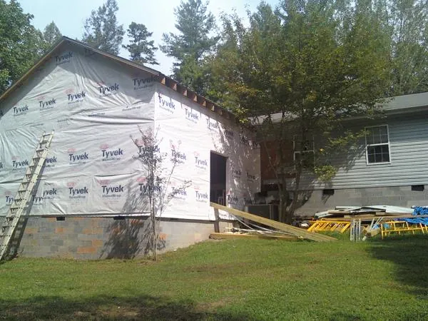 Tyvek wrapped gable on a new room addition beside an existing home in North Branch