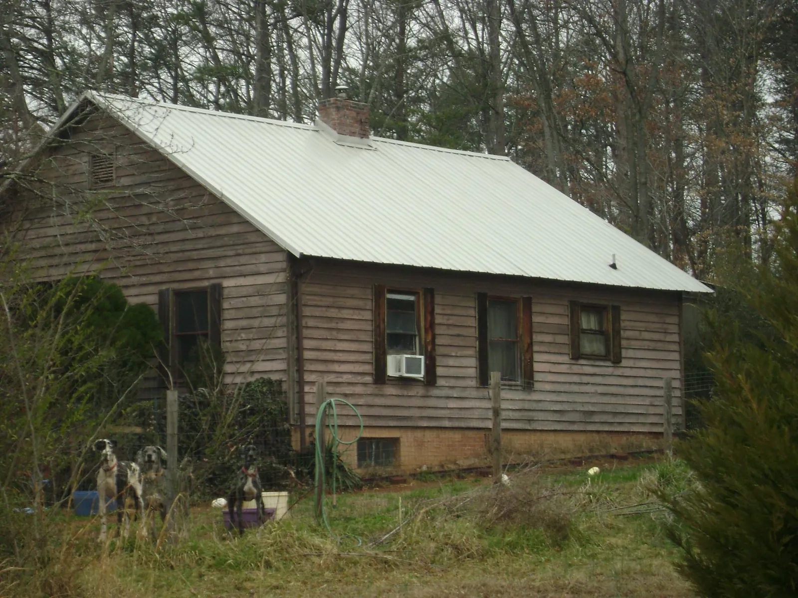 White metal roof on an old wood sided farmhouse, from a Metal Roof Installation job in North Branch